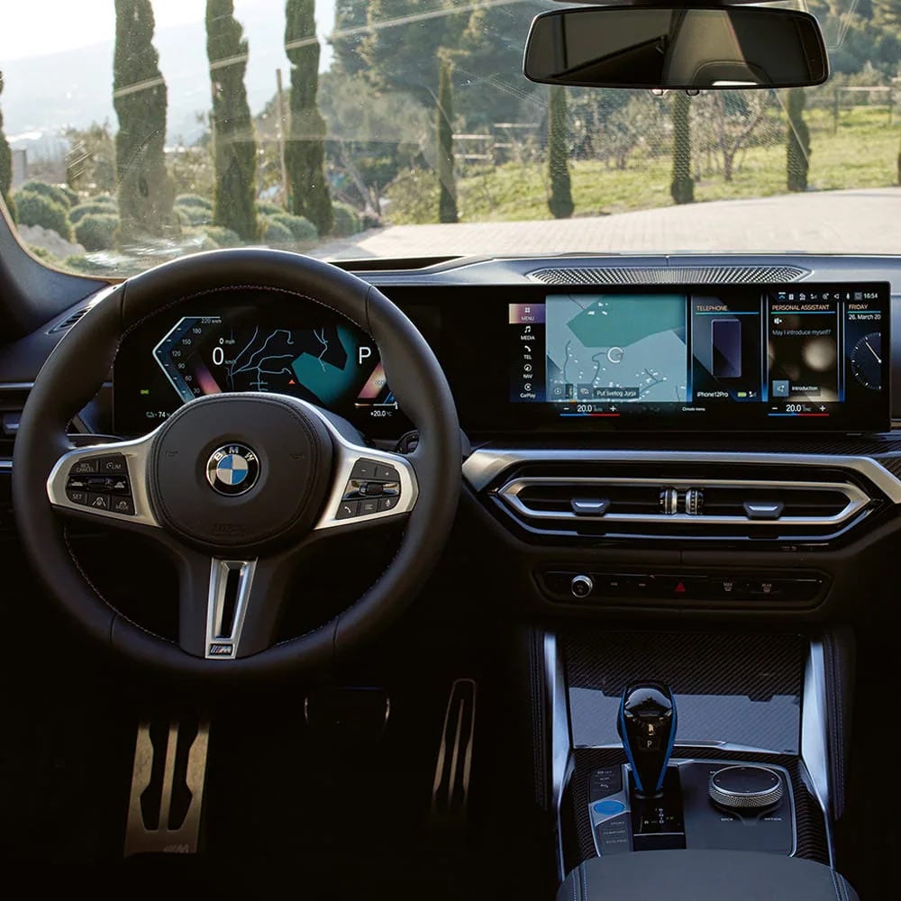 A driver's eye view of steering wheel and controls of the BMW i4 | BMW of Okemos in Okemos MI