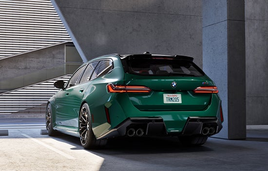 Green BMW M5 Touring parked in garage. | BMW of Okemos in Okemos MI