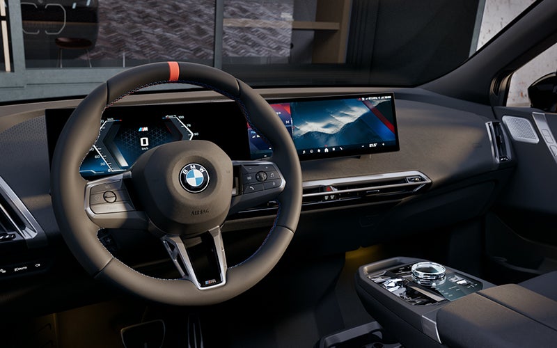 Interior steering wheel and dashboard of the BMW iX M70. | BMW of Okemos in Okemos MI